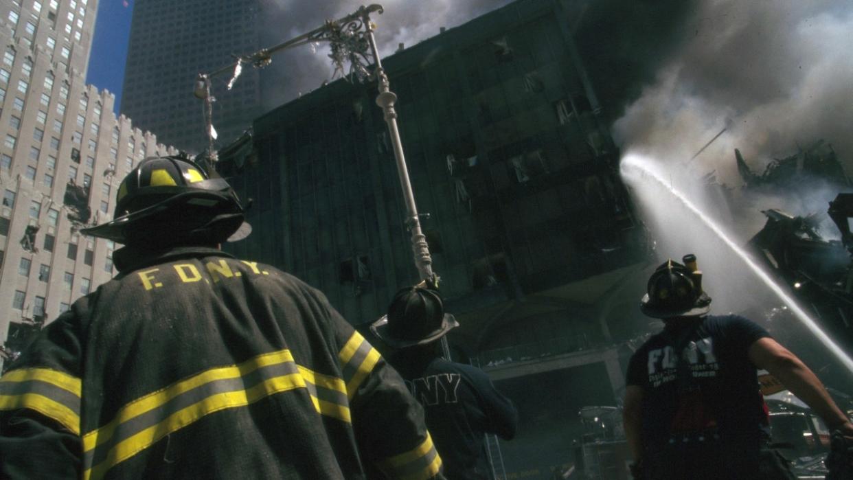 Color photograph of a New York firefighter amid the rubble of the World Trade Center after the September 11 attacks.