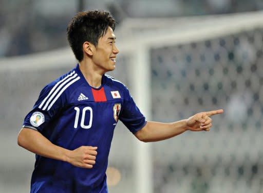 Japanese forward Shinji Kagawa celebrates after scoring his team's fourth goal against Tajikistan during their Asian qualifying round football match for the 2014 World Cup in Osaka. Japan won 8-0