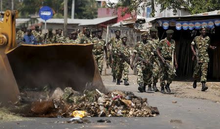 Soldiers walk during a protest against President Pierre Nkurunziza's decision to run for a third term in Bujumbura, Burundi, May 29, 2015. REUTERS/Goran Tomasevic