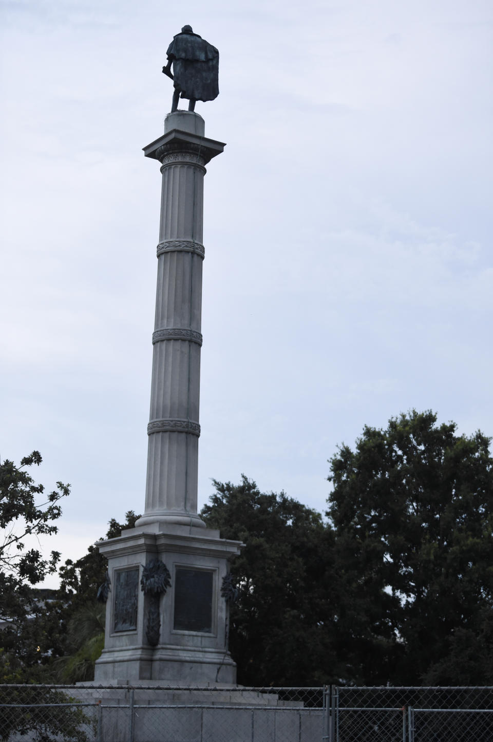 A 100-foot monument to former U.S. vice president and slavery advocate John C. Calhoun towers over a downtown square Tuesday, June 23, 2020, in Charleston, S.C. Officials in Charleston voted unanimously Tuesday to remove the statue from a downtown square, the latest in a wave of actions arising from protests against racism and police brutality against African Americans. (AP Photo/Meg Kinnard)