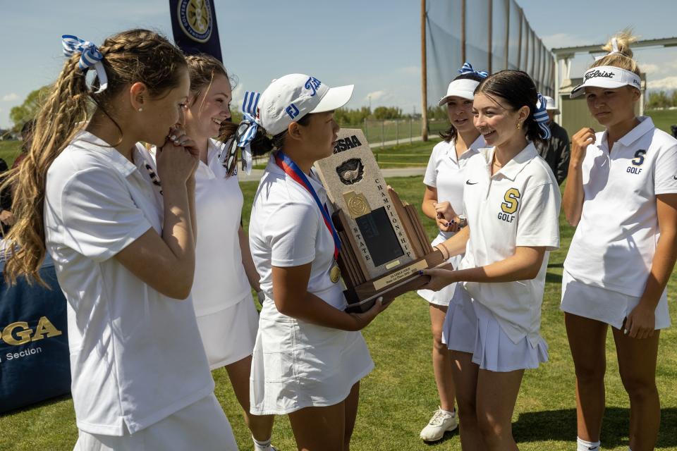 Skyline players admire their championship trophy after taking the 5A high school state championships at Remuda Golf Course in Ogden on Tuesday, May 9, 2023. | Scott G Winterton, Deseret News