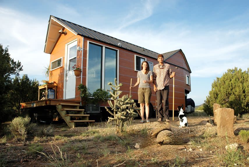 <p>Carrie and Shane Caverly built their 200-square-foot house in the spring of 2012 after growing tired of paying mortgages and rent. Built on a trailer, the house features a low-maintenance steel roof, an on-demand hot water heater, an incinerating toilet, and a passive solar design. Carrie, an architectural designer, and Shane, a custom builder, now run <a href="http://clotheslinetinyhomes.com/shop/" rel="nofollow noopener" target="_blank" data-ylk="slk:Clothesline Tiny Homes;elm:context_link;itc:0;sec:content-canvas" class="link ">Clothesline Tiny Homes</a>, offering downloadable tiny house plans, design consulting, and custom building. After living in their tiny house for 20 months in New Mexico, the couple has now moved to Colorado, where they're building a 1,000-square-foot home. (Their tiny house will serve as a guest cottage.) </p><p><a class="link " href="http://clotheslinetinyhomes.com/house-photos/" rel="nofollow noopener" target="_blank" data-ylk="slk:SEE INSIDE;elm:context_link;itc:0;sec:content-canvas">SEE INSIDE</a></p>