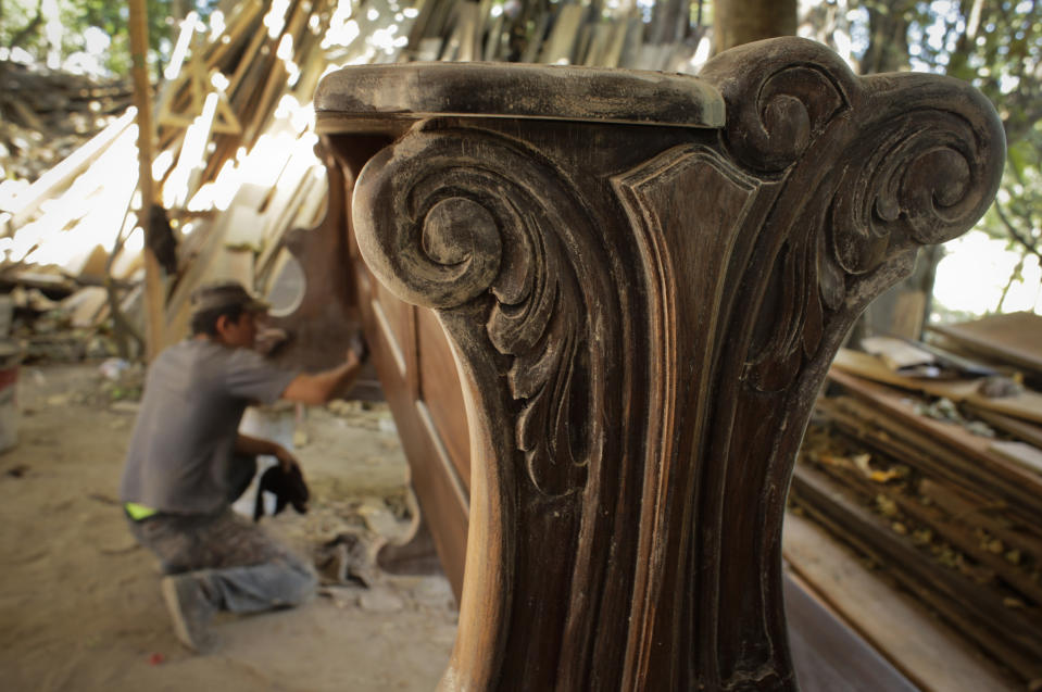 A worker varnishes a pew that will be used by pilgrims during Mass on World Youths Day, to be celebrated by Pope Francis, at Hernan Guardia's carpentry workshop where the Pope's chair is also being built in Los Pozos, Panama, Saturday, Jan. 12, 2019. The Argentine pontiff visit Panama Jan. 23-27. (AP Photo/Arnulfo Franco)