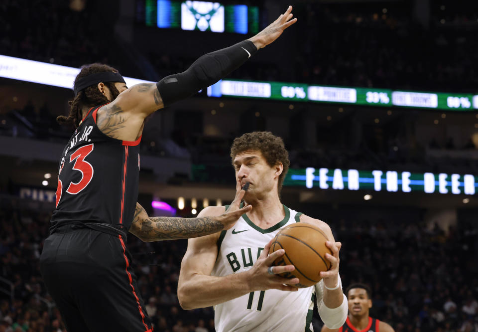 Milwaukee Bucks' Brook Lopez(11) drives against Toronto Raptors' Gary Trent Jr. during the first half of an NBA basketball game Friday, April 5, 2024, in Milwaukee. (AP Photo/Jeffrey Phelps)