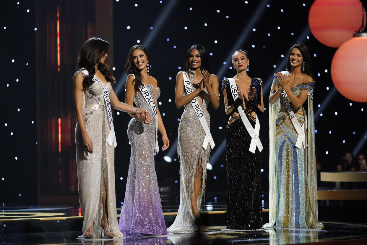 The final five contestants are announced during the final round of the 71st Miss Universe Beauty Pageant in New Orleans, Saturday, Jan. 14, 2023. Left to right are Miss Dominican Republic Andreina Martinez, Miss Curacao Gabriela Dos Santos, Miss Puerto Rico Ashley Carino, Miss USA R'Bonney Gabriel and Miss Venezuela Amanda Dudamel. (AP Photo/Gerald Herbert)