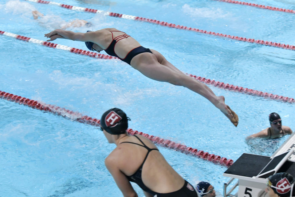 FILE - Transgender swimmer Lia Thomas, center, begins her leg of the hundred yard freestyle medley during a meet with Harvard on Saturday, Jan. 22, 2022, at at Harvard University in Cambridge, Mass. Three years ago, she was on the men's team for Penn. This year, she is setting records as critics say it is not fair for her to swim against women after her transition. Next week, she will swim in the Ivy League championships. (AP Photo/Josh Reynolds, File)