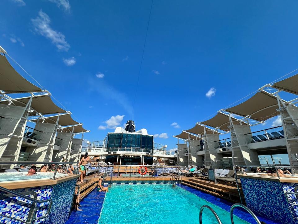 pool on a cruise ship with a few people sitting around the deck