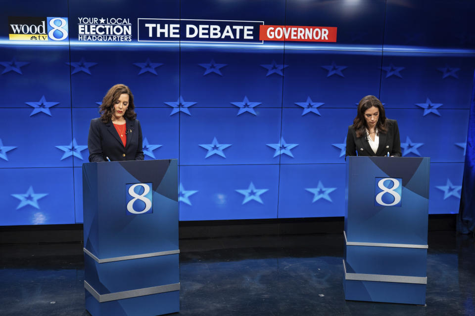 Democratic Gov. Gretchen Whitmer, left, and GOP gubernatorial candidate Tudor Dixon make notes before a Michigan Governor debate, Thursday, Oct. 13, 2022, at WOOD-TV in Grand Rapid, Mich. (Bryan Esler/Nexstar Media Group/WOOD-TV via AP)