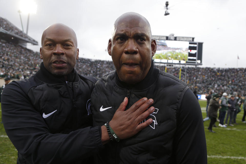 Michigan State coach Mel Tucker, right, is congratulated by athletic director Alan Haller following a 37-33. win over Michigan in an NCAA college football game, Saturday, Oct. 30, 2021, in East Lansing, Mich. (AP Photo/Al Goldis)