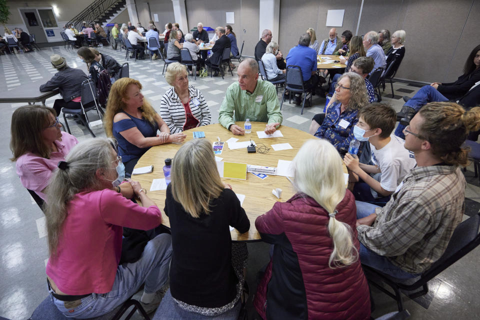 Democrat Paddy McGuire, incumbent Mason County auditor, center, talks with voters during before a "candidate speed-dating" style forum, Thursday, Oct. 13, 2022, in Shelton, Wash. (AP Photo/John Froschauer)