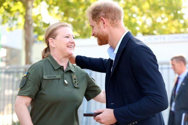 <p>Chris Jackson/Getty Images</p> Prince Harry chats with Minister for Veterans' Affairs of Ukraine Yulia Laputina at the 2023 Invictus Games in Duesseldorf, Germany.