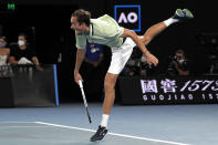 Daniil Medvedev of Russia serves to Stefanos Tsitsipas of Greece during their semifinal match at the Australian Open tennis championships in Melbourne, Australia, Friday, Jan. 28, 2022. (AP Photo/Simon Baker)