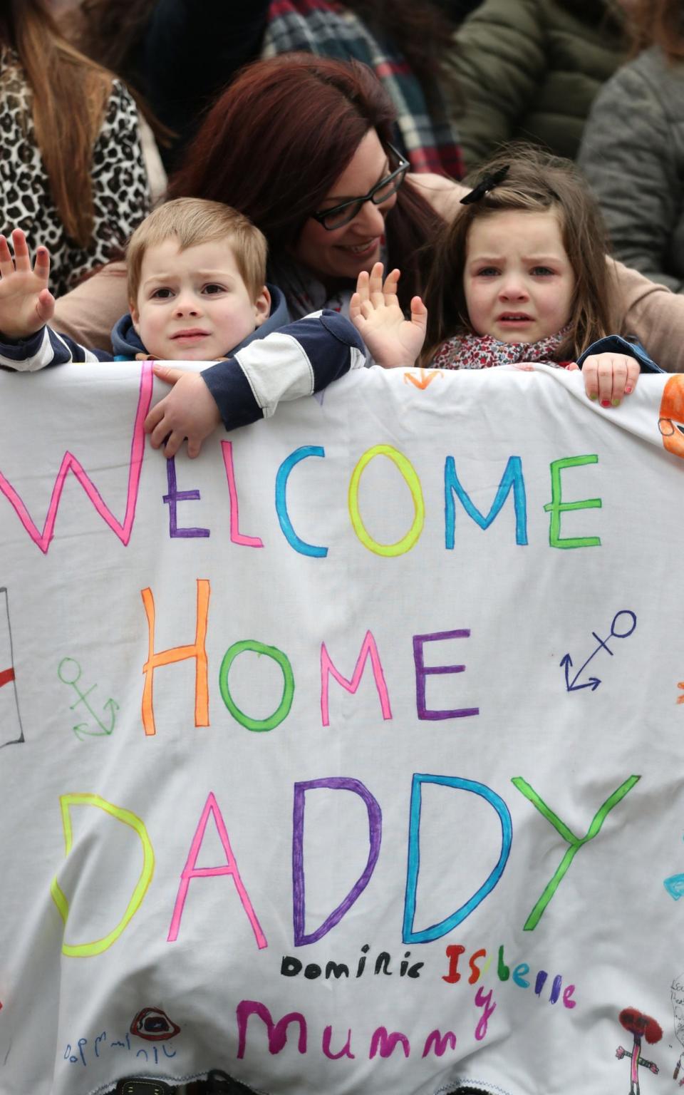 Luisa Jeffrey from Sussex, and her daughter Isabelle, 5, and son Dominic, 4, await Adam Jeffrey's arrival - Credit:  Andrew Matthews/PA