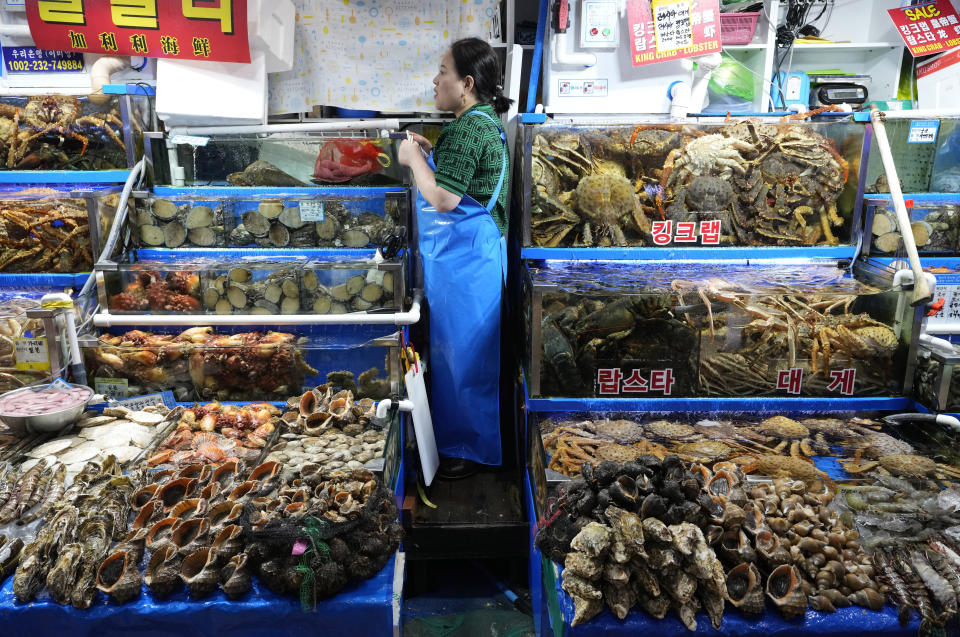 A fish monger waits for customers at the Noryangjin Fisheries Wholesale Market in Seoul, South Korea, Friday, July 7, 2023. South Korea's government on Friday formally endorsed the safety of Japanese plans to release treated wastewater from the crippled Fukushima nuclear power plant into sea as it tried to calm people's fears about food contamination. (AP Photo/Ahn Young-joon)