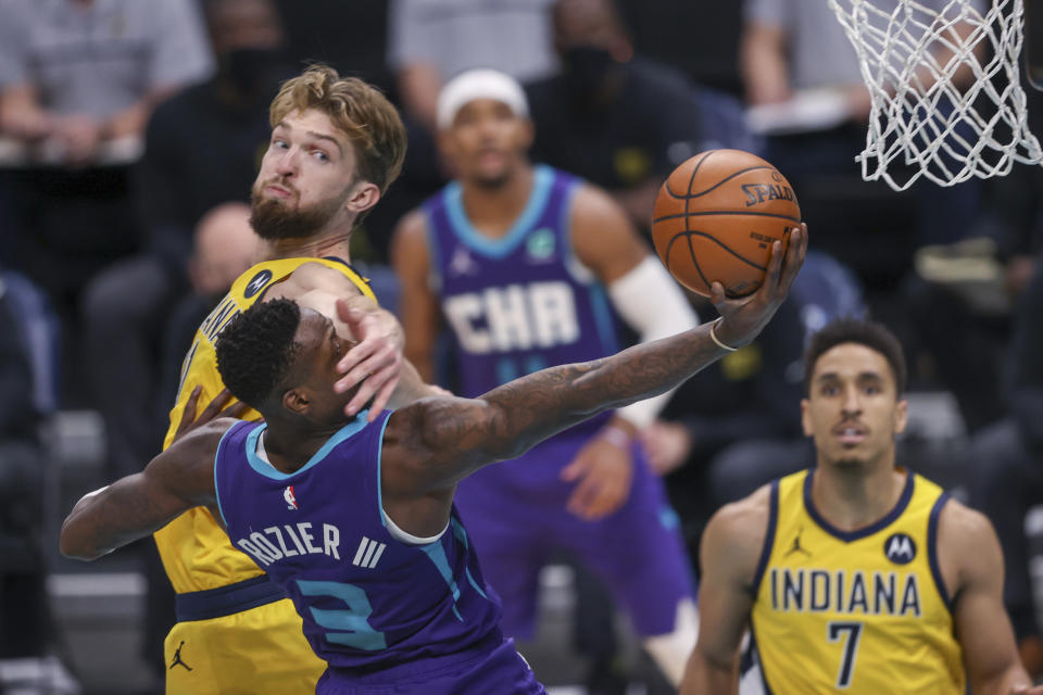 Charlotte Hornets guard Terry Rozier (3) is fouled by Indiana Pacers forward Domantas Sabonis on a drive to the basket during the second half of an NBA basketball game in Charlotte, N.C., Wednesday, Jan. 27, 2021. (AP Photo/Nell Redmond)