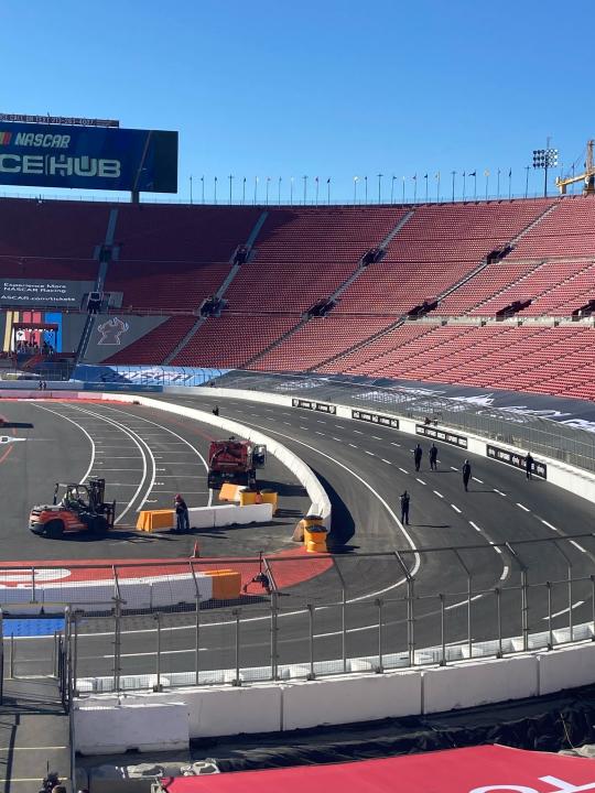 A temporary auto racing track is viewed inside LA Coliseum ahead of a NASCAR exhibition race in Los Angeles, Friday, Feb. 4, 2022. NASCAR is hitting Los Angeles a week ahead of the Super Bowl, grabbing the spotlight with its wildest idea yet: The Clash, the unofficial season-opening, stock-car version of the Pro Bowl, will run at the iconic coliseum in a made-for-Fox Sports spectacular. (AP Photo/Jenna Fryer)