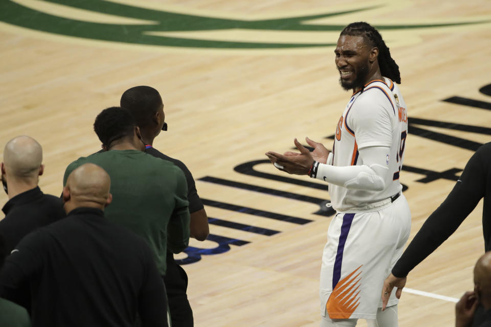 Phoenix Suns' Jae Crowder reacts as he talks with members of the Milwaukee Bucks bench during the second half of Game 3 of basketball's NBA Finals, Sunday, July 11, 2021, in Milwaukee. (AP Photo/Aaron Gash)