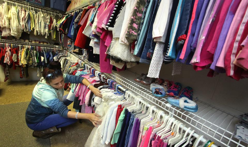 Muriah Osborne looks through the children’s clothes Saturday morning, Nov. 20, 0221, at the infant and toddler clothing closet at Polkville Baptist Church.