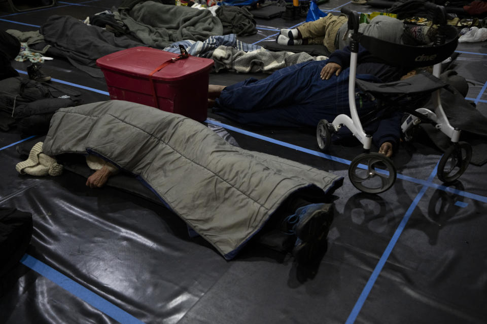 People rest at Friendly House which opened as an emergency warming shelter on Saturday, Jan. 13, 2024, in Portland, Ore. (AP Photo/Jenny Kane)