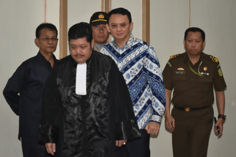 Jakarta's Christian governor Basuki Tjahaja Purnama (2nd R), popularly known as Ahok, arrives at a courtroom for a verdict and sentence in his blasphemy trial