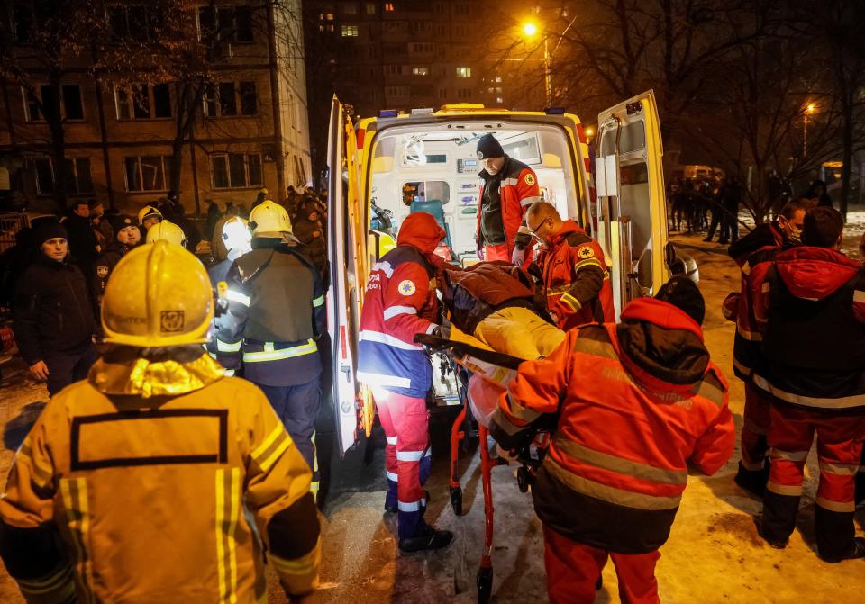 Medics carry a wounded local resident at a site of an apartment building damaged during a Russian missile strike (REUTERS)
