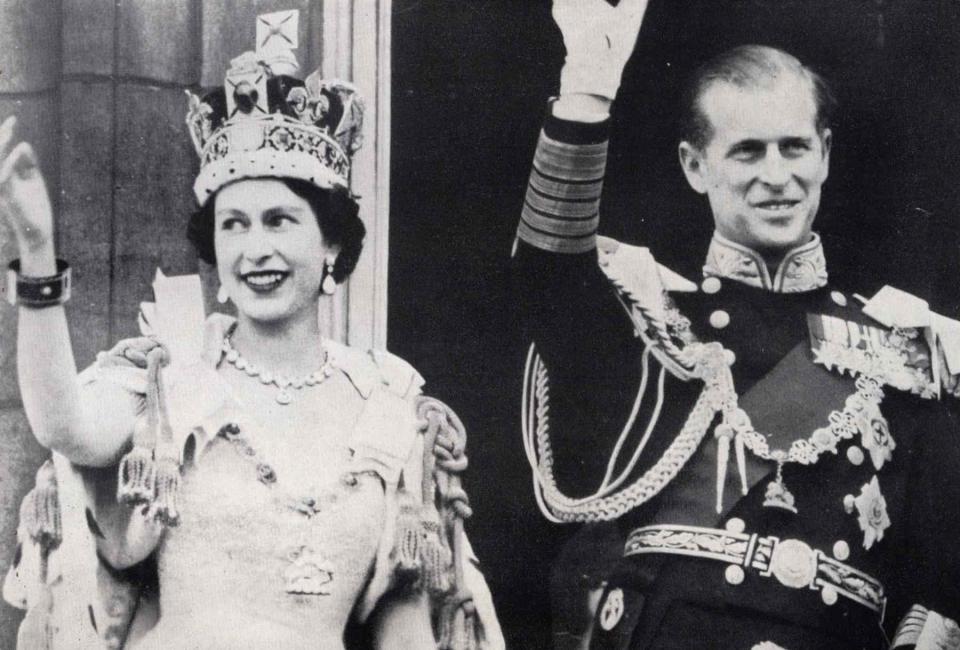 Universal History Archive/UIG via Getty  Queen Elizabeth II and Prince Phillip wave from Buckingham Palace.