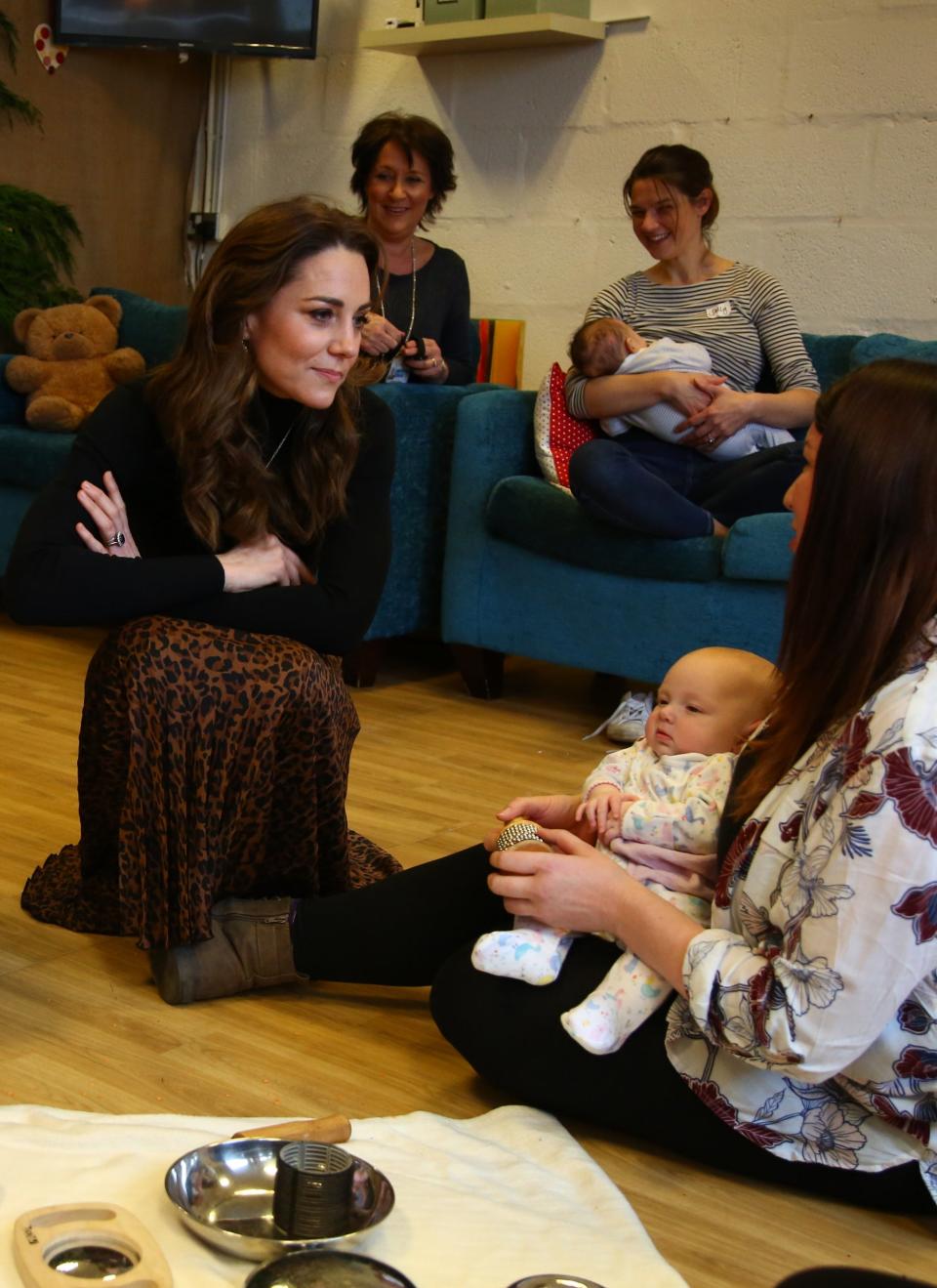 The Duchess of Cambridge chats with mothers and their children during a visit to Ely and Careau Childrens Centre (Getty Images)