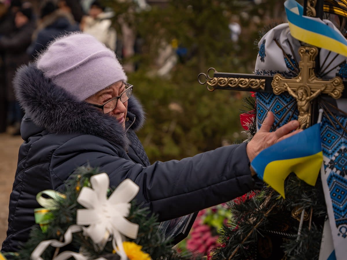 An elderly resident of Bakhmut cries as she marks the anniversary of Russia’s invasion of Ukraine (Bel Trew)