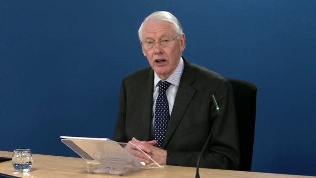 Inquiry chairman Sir Martin Moore-Bick reading a statement