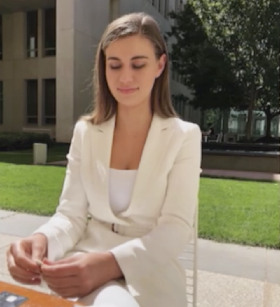 A photo of Brittany Higgins in a white suit.