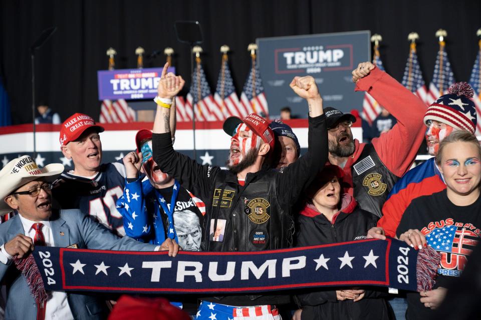 Supporters gather for a photo before former president Donald J. Trump speaks at a campaign rally at SNHU Arena in Manchester, NH, on Saturday, January 20, 2024.