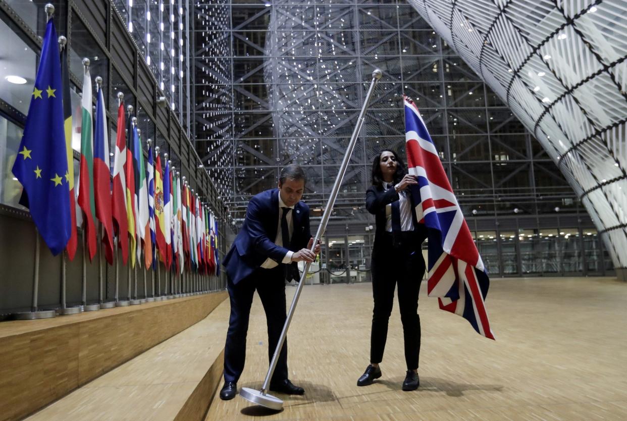 Officials remove the British flag at European Union Council in Brussels: REUTERS