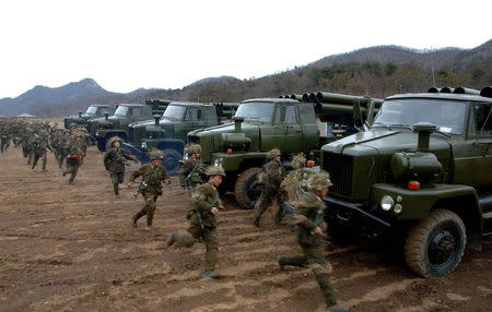 North Korean soldiers run as they attend military training in an undisclosed location. REUTERS/KCNA