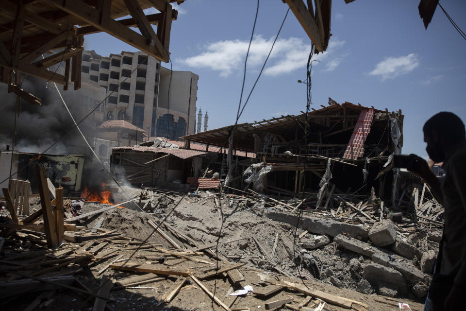 Smoke and fire rises from a beachside cafe after it was hit by an Israeli airstrike, in Gaza City, Monday, May 17, 2021. (AP Photo/Khalil Hamra)