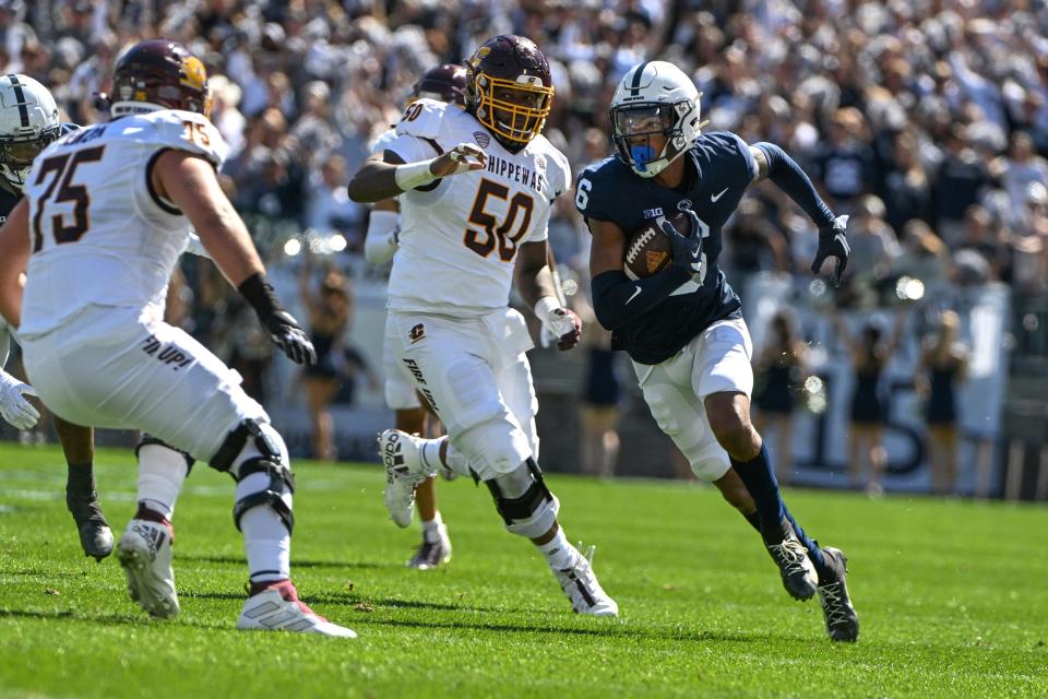 Penn State safety Zakee Wheatley (6) returns an interception as Central Michigan offensive lineman Jamezz Kimbrough (50) chases during the first half of an NCAA college football game, Saturday, Sept. 24, 2022, in State College, Pa. (AP Photo/Barry Reeger)