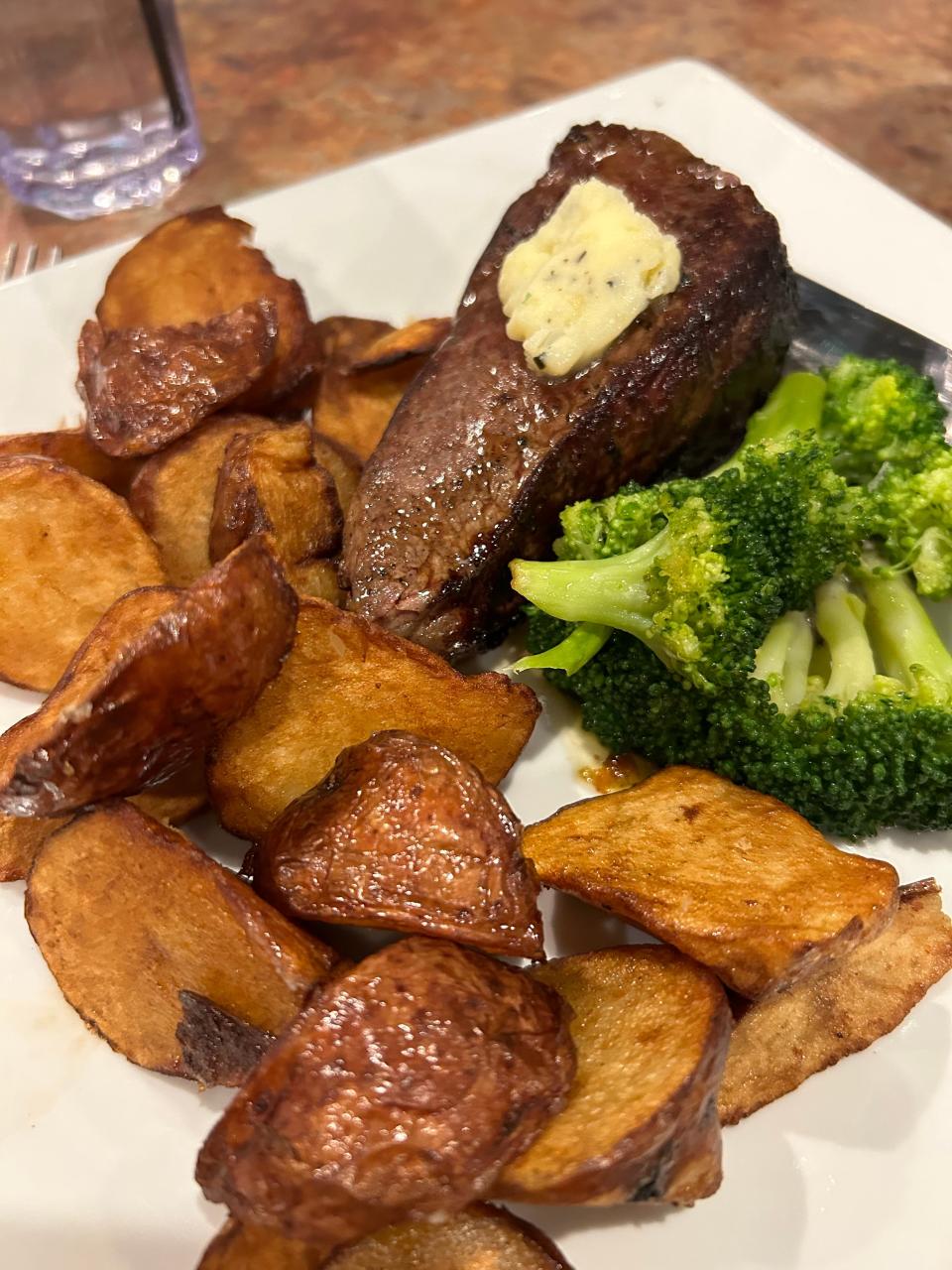 An 8-ounce sirloin steak is served with house compound butter, confit redskin potatoes and sauteed broccoli at Caston & Main Brew Yard.