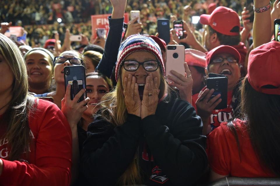 <p>Supporters watch as President Trump speaks to a crowd in El Paso on Monday night. </p>