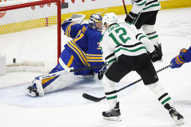 Dallas Stars center Radek Faksa (12) puts the puck past Buffalo Sabres goaltender Eric Comrie (31) during the third period of an NHL hockey game, Thursday, March 9, 2023, in Buffalo, N.Y. (AP Photo/Jeffrey T. Barnes)