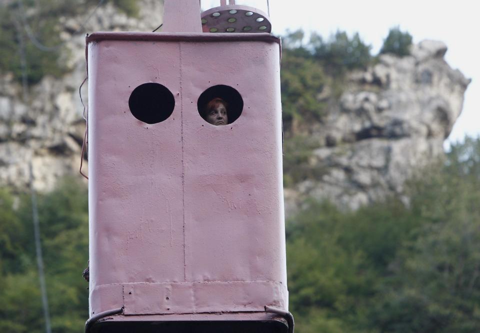 A commuter looks out from a cable car in the town of Chiatura