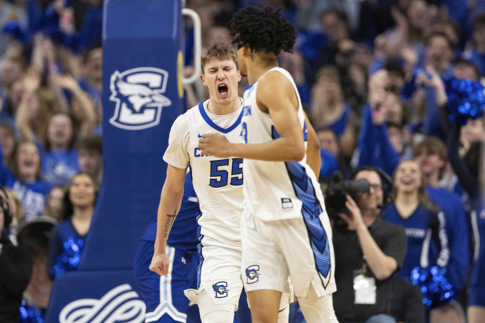 Creighton's Baylor Scheierman, left, celebrates after Trey Alexander, right, made a basket and drew a foul call against Seton Hall during the first half of an NCAA college basketball game Wednesday, Feb. 28, 2024, in Omaha, Neb. (AP Photo/Rebecca S. Gratz)