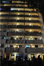 Residents gather at corridors of nearby HDB flats to watch the SDP rally in Clementi. Sunday, May 1. (Yahoo! photo/ Faris Mokhtar) 