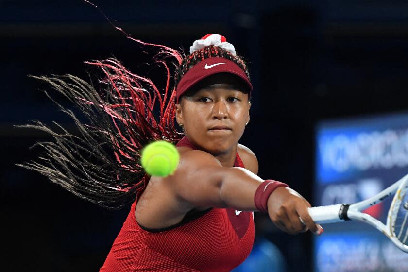 Japan's Naomi Osaka returns the ball to Czech Republic's Marketa Vondrousova during their Tokyo 2020 Olympic Games women's singles third round tennis match at the Ariake Tennis Park in Tokyo on July 27, 2021. (Photo by Tiziana FABI / AFP) (Photo by TIZIANA FABI/AFP via Getty Images)