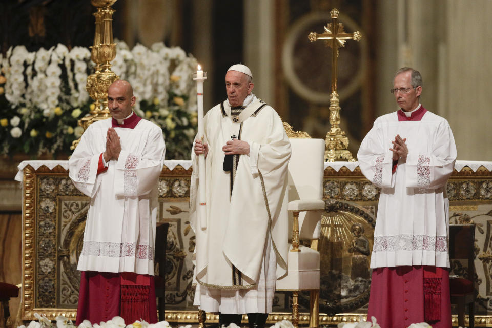 Pope Francis holds a candle as he presides over a solemn Easter vigil ceremony in St. Peter's Basilica at the Vatican, Saturday, April 21, 2019. (AP Photo/Gregorio Borgia)