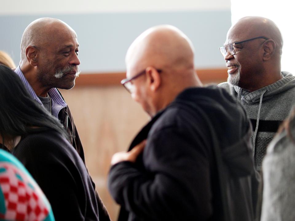 Exoneree Perry Lott, left, speaks with Glynn Simmons, right, before Judge Amy Palumbo ruled Tuesday to approve Simmons' "actual innocence" claim.