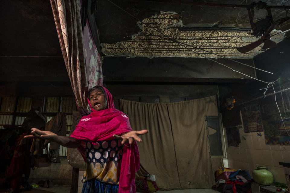 A homeless Mangla Kumari laments about the potentially dangerous condition of the dilapidated shelter they live in, in New Delhi, Wednesday, Dec. 28, 2022. Even though the city’s night shelters are a refuge to many who would otherwise find themselves sleeping near traffic-busy roundabouts and underpasses, most people there live in harsh conditions. Many night shelters are overcrowded, with unclean toilets. Rooms stench of rot. (AP Photo/Altaf Qadri)