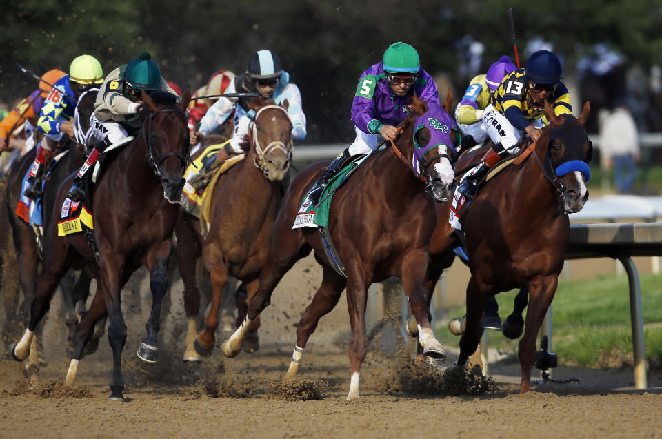 Victor Espinoza rides California Chrome around turn four to a victory during the 140th running of the Kentucky Derby horse race at Churchill Downs Saturday, May 3, 2014, in Louisville, Ky. (AP Photo/Matt Slocum)