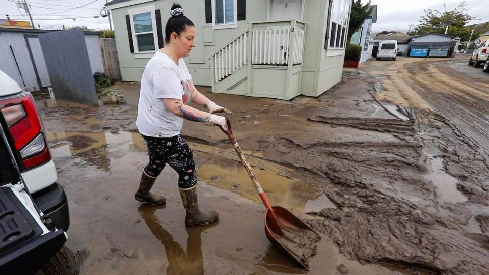 Melissa Stirlen cleans up at the Silver City West mobile home park in Morro Bay during a break in the storm track on Jan. 11, 2023. She and her parents, who are managers at the park, helped residents evacuate after floodwaters entered the park.