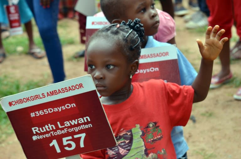 A young girl carries a sign with a name of a girl as family and friends mark 500 days since the abductions of the Chibok schoolgirls by Boko Haram, during a rally to press for their release in Abuja, on August 27, 2015