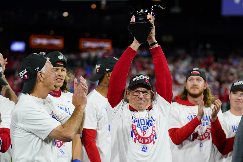 Philadelphia Phillies interim manager Rob Thomson celebrates with the trophy after winning the baseball NL Championship Series in Game 5 against the San Diego Padres on Sunday, Oct. 23, 2022, in Philadelphia.(AP Photo/Matt Slocum)