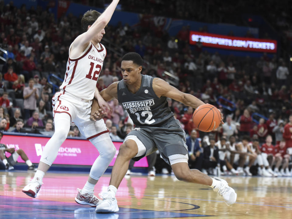 Mississippi State guard Robert Woodard (12) tries to push past Oklahoma guard Austin Reaves (12) during the second half of an NCAA college basketball game in Oklahoma City, Saturday, Jan. 25, 2020. (AP Photo/Kyle Phillips)